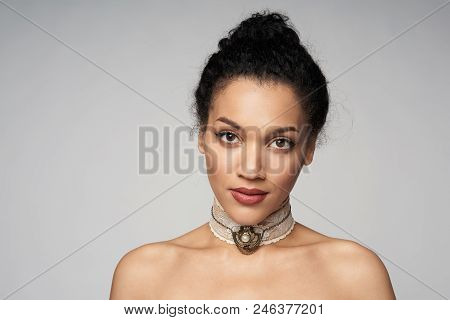 Beauty Closeup Portrait Of Beautiful Mixed Race Woman Wearing Chocker Looking At Camera, Isolated On