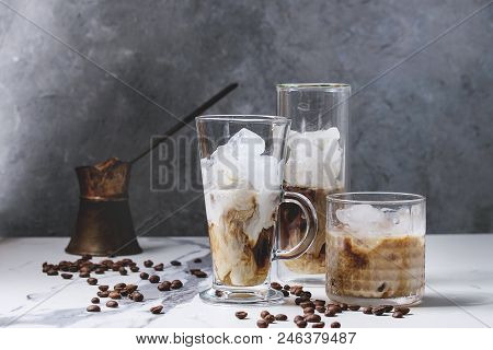 Iced Coffee Cocktail Or Frappe With Ice Cubes And Cream Served In Three Different Glasses With Vinta