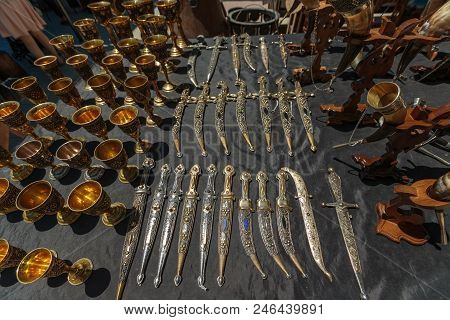 Daggers And Knives In A Steel Case And Metal Wine Cups.
