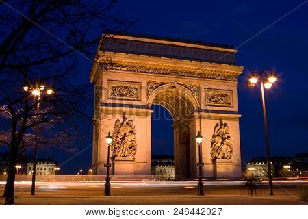 arc de Triomphe (Triumphal Arch) in Chaps Elysees at sunset, Paris, France. Architecture and landmarks of Paris. Postcard of Paris
