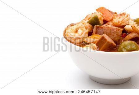 A Bowl Of Cajun Seafood Gumbo On A White Background
