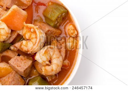 A Bowl Of Cajun Seafood Gumbo On A White Background