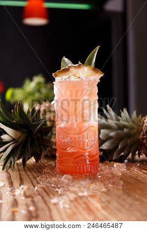 A Red Pina Colada Coctail Is Made Of Ripe Pineapples And Is Presented In An Interesting Glass.