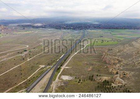 The Canvas Of The Road Crossing The Valley Between The Mountains From A Bird's Eye View