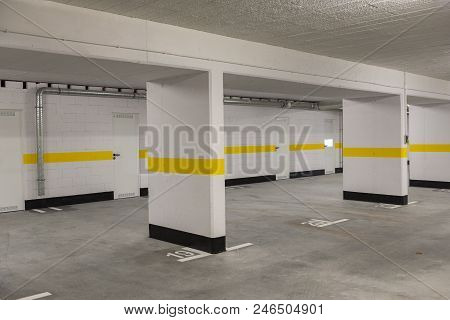 Typical Underground Car Parking Garage In A Modern Apartment House.