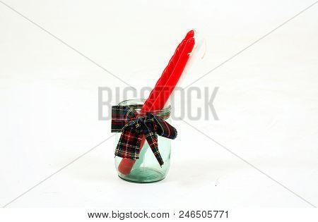 A Glass Retro Jar With A Cover With A Winter Ornament And A Red Straw On A Warm Background Of A Ligh