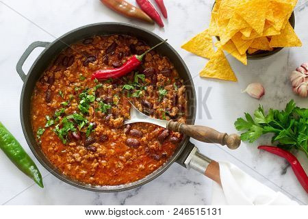 Mexican And American Food Chili Con Carne Served With Nachos, Pepper And Herbs. Selective Focus.