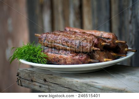 Lulya Kebab From Meat On A White Plate And Wooden Board.