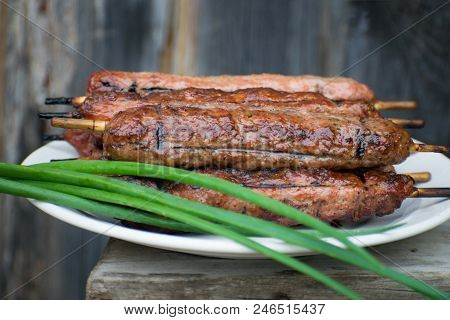 Lulya Kebab From Meat On A White Plate And Wooden Board.