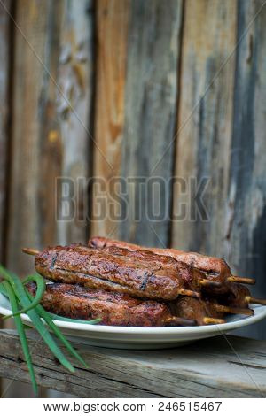 Lulya Kebab From Meat On A White Plate And Wooden Board.