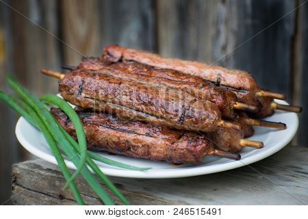 Lulya Kebab From Meat On A White Plate And Wooden Board.