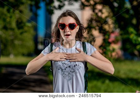 Beautiful Schoolgirl Girl. Summer Nature After School. Glasses, Heart Shaped. Smiles Happily. Gestur