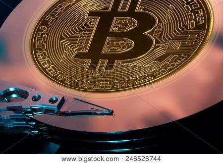 Bitcoin Superimposed On The Discs Of A Hard Drive Storage To Illustrate Bitcoin Mining