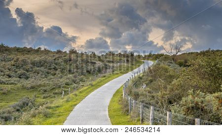 Road Through Dunes With Clouds In Province Of Zeeland, Netherlands