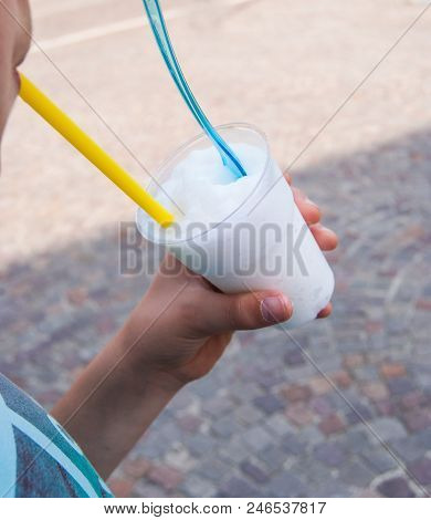 Granita To Take Away In A Plastic Cup With Blue Spoon And Yellow Drinking Straw