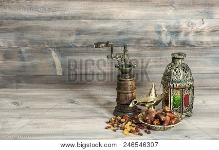 Vintage Oriental Latern And Mill. Raisins And Dates On Wooden Background. Islamic Holidays