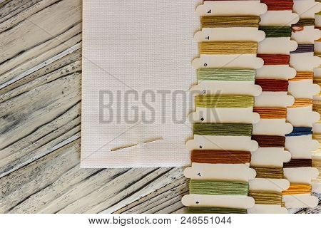 Set Of Multicolored Threads For Sewing And Embroidering On A Wooden Background. Hobbies, Clothes Rep