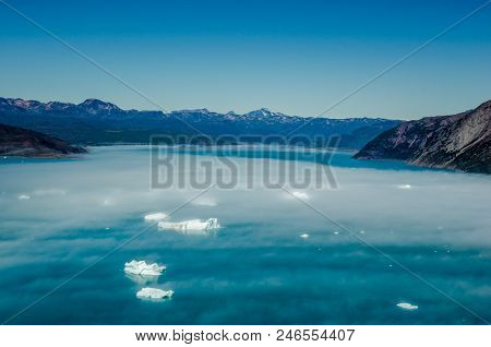 Icebergs Under The Fog Near Narsarsuaq, Greenland