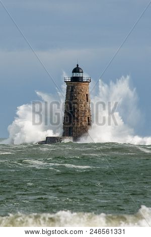 Huge Waves Break Around The Stone Tower Of Whalback Lighthouse In Maine During Rare High Tide.
