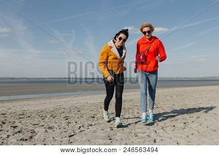 Happy Girls Walking On Sandy Beach, Saint Michaels Mount, Normandy, France