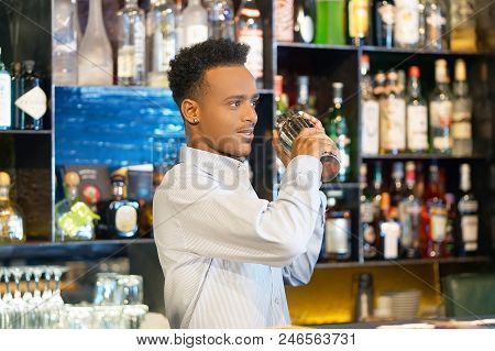 Professional Bartender Man Holding In Hands A Shaker With A Fresh Delicious Cocktail. Bartender Shak