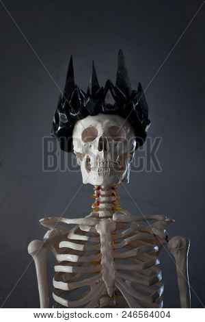 Skull In The Crown. Grim Necromancer In Gothic Crown. Gray Background, Halloween Concept