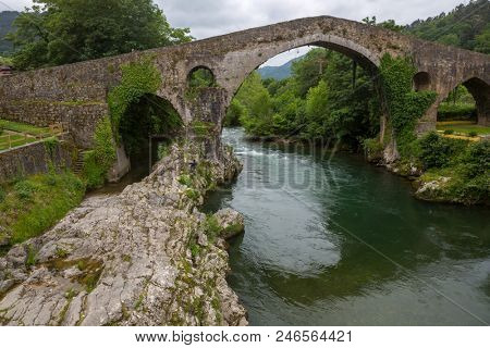 the Roman bridge built in the late 13th century over the Sella River in Cangas de Onis, Asturias, Spain.