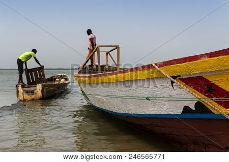 Cacheu, Republic Of Guinea-bissau - February 1, 2018: Fishermen Preparing Their Canoes In The Port O