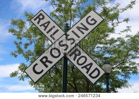 A Black & White Railroad Tracks Crossing Sign