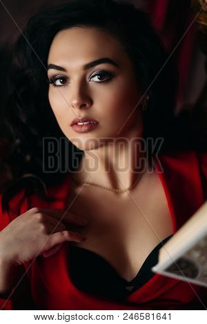 Close Up Portrait Of Sexy Young Girl In Red Dress With Decolte, Professional Make Up And Volumed Hai