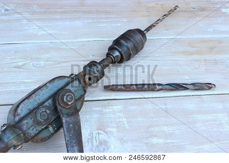 Old Hand Drill Against The Background Of Boards
