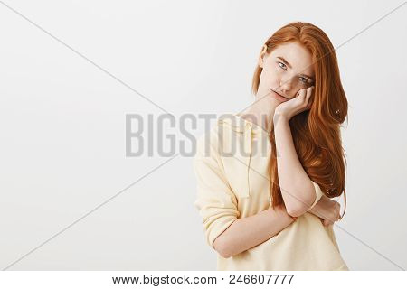 Studying Makes Me Bored. Portrait Of Fed Up Annoyed Redhead Woman Holding Head On Hand, Rolling Eyes