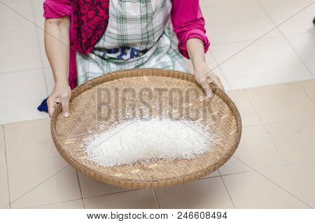 Housewife Winnowing Rice By Using Bamboo Basketwork For Separate Between Rice And Rice Husk.selectiv