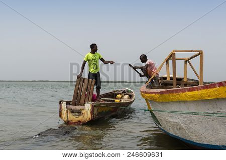 Cacheu, Republic Of Guinea-bissau - February 1, 2018: Fishermen Preparing Their Canoes In The Port O