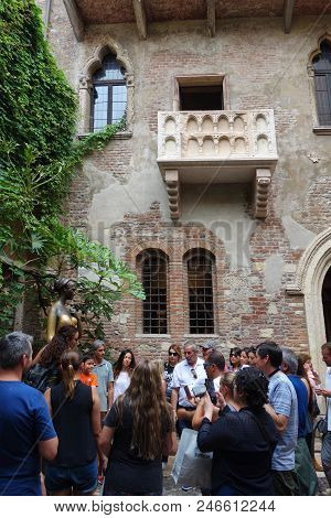 Verona, Italy - 11 June 2018: People Under The Famous Balcony And Next To The Juliet Statue In The G