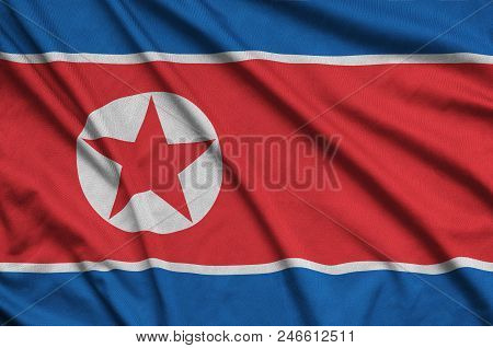 North Korea Flag  Is Depicted On A Sports Cloth Fabric With Many Folds. Sport Team Waving Banner