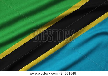 Tanzania Flag  Is Depicted On A Sports Cloth Fabric With Many Folds. Sport Team Waving Banner