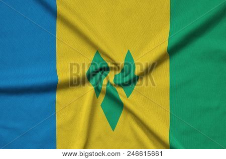 Saint Vincent And The Grenadines Flag  Is Depicted On A Sports Cloth Fabric With Many Folds. Sport T
