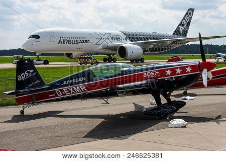 Berlin-april 27, 2018: The Two-seat Aerobatic Monoplane Extra Ea-300s (foreground) And The Wide-body