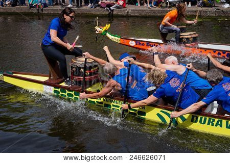 Leiden, Holland, June 23th, 2018: Traditional Red Dragon Boat Races In Leiden Canal, Rowing Teams Co