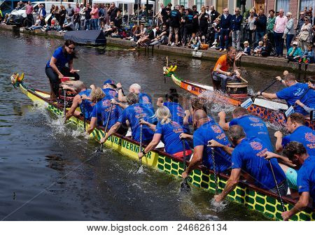Leiden, Holland, June 23th, 2018: Traditional Red Dragon Boat Races In Leiden Canal, Rowing Teams Co