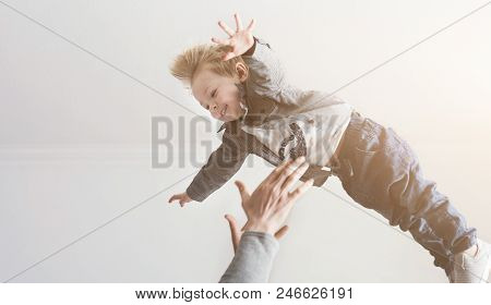 Father And Boy Spending Time Together, Man Throw Up His Son At Home In Living Room