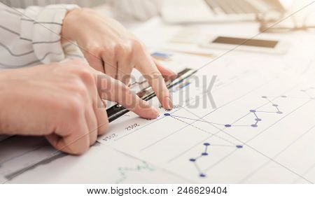 Business Man And Woman Point To Falling Graph Of Stock Market, Discussing Decrease Of Profit, Financ