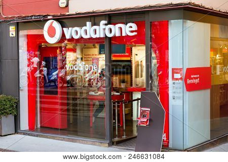 Blanes, Spain - 30 May, 2018: Signboard Of Telecommunications Company Vodafone On Glass Wall Of Buil