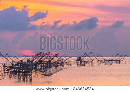 golden sky above fishing trap in Pak Pra Talay Noi sea Phatthalung south of Thailand