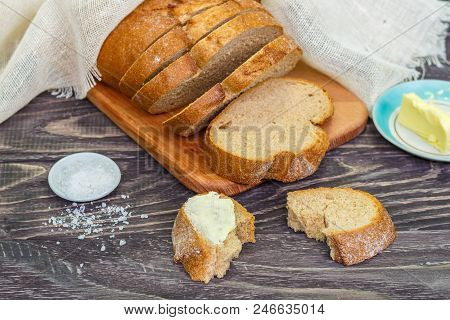 Still Life With Slices Of Bread On A Wooden Background