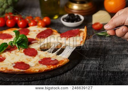 Pizza On The Table Stretching Cheese With Cut Couscous, Side View