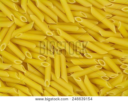 Uncooked Yellow Italian Pasta Penne Doppia Rigatura Texture Close-up