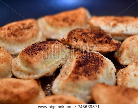 A close up shot of fried perogies.