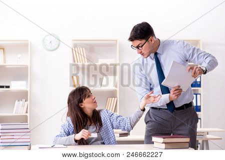 Male lecturer giving lecture to female student